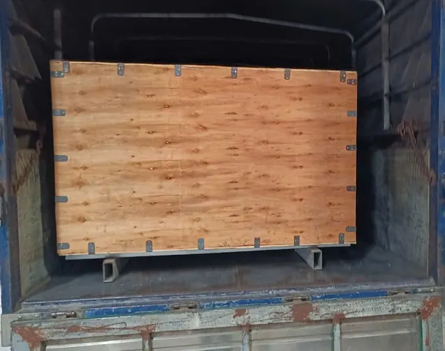 Large wooden crate positioned in a truck bed